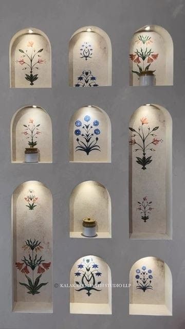 an assortment of vases with flowers painted on them in different shapes and sizes, all lined up against a wall