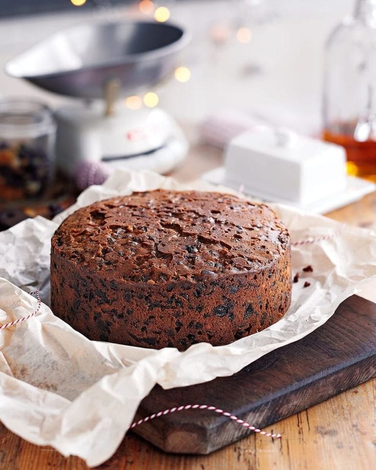 a cake sitting on top of a wooden cutting board