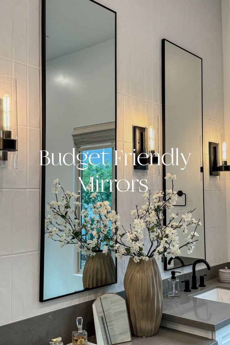 a bathroom with three mirrors and flowers in vases on the sink counter next to it