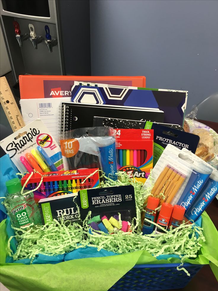 a basket filled with school supplies on top of a table