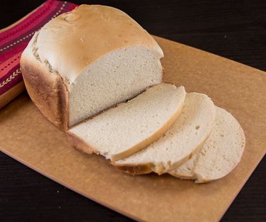 sliced loaf of bread sitting on top of a cutting board