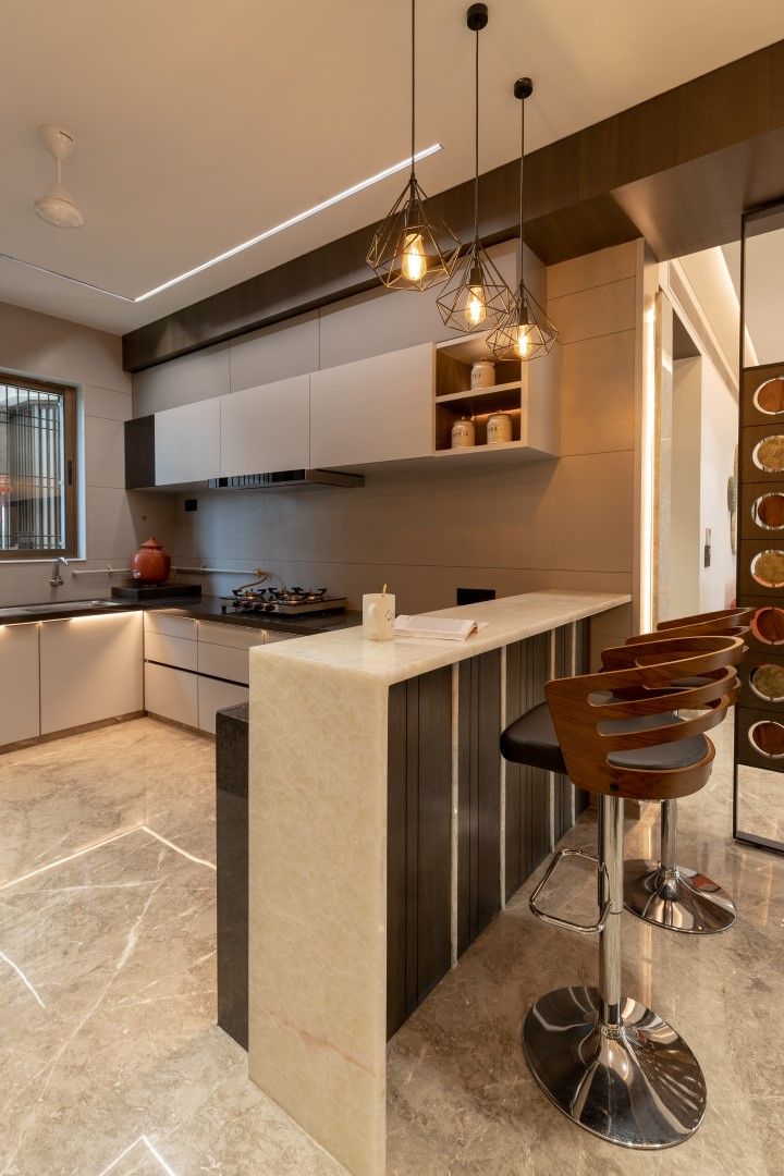 a modern kitchen with marble counter tops and bar stools in the middle of the room