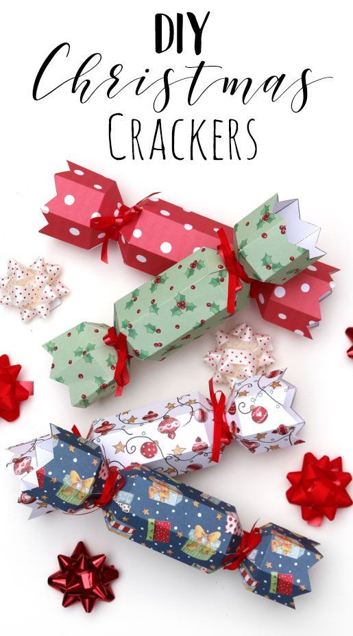 several christmas crackers with bows and snowflakes around them on a white background