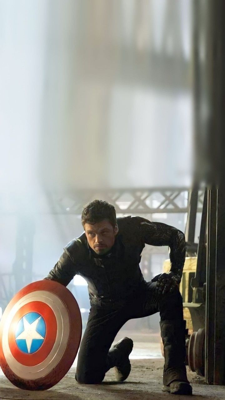 the man is posing with his shield in front of him