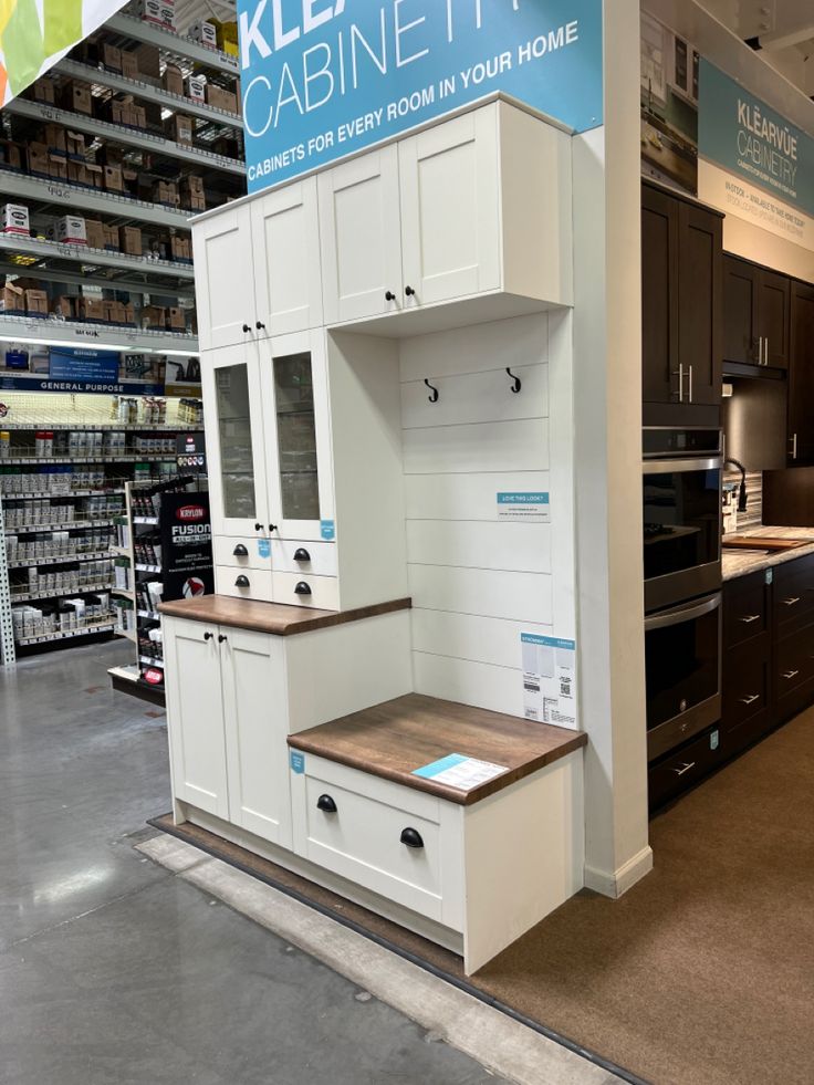 the kitchen cabinets are all white and have blue labels on them