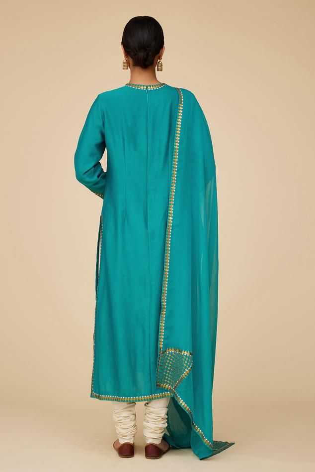 Teal blue full sleeves straight kurta in chanderi base with sequin tikki jaal embroidery on the neckline, sleeves hem and borders. Paired with ivory cotton churidar and embroidered viscose organza dupatta.
Components: 3
Pattern: Embroidery
Type Of Work: Sequin Tikki Jaal
Neckline: Round
Sleeve Type: Full
Fabric: Kurta: Chanderi, Dupatta: Viscose Organza, Churidar: Cotton
Color: Blue
Other Details: 
Length:
Kurta: 46inches
Churidar: 58inches
Dupatta: 2.5metres
Occasion: Puja - Aza Fashions Jaal Embroidery, Cotton Churidar, Chanderi Dupatta, Blue Kurta, Straight Kurta, Pattern Embroidery, Organza Dupatta, Churidar, Full Sleeves