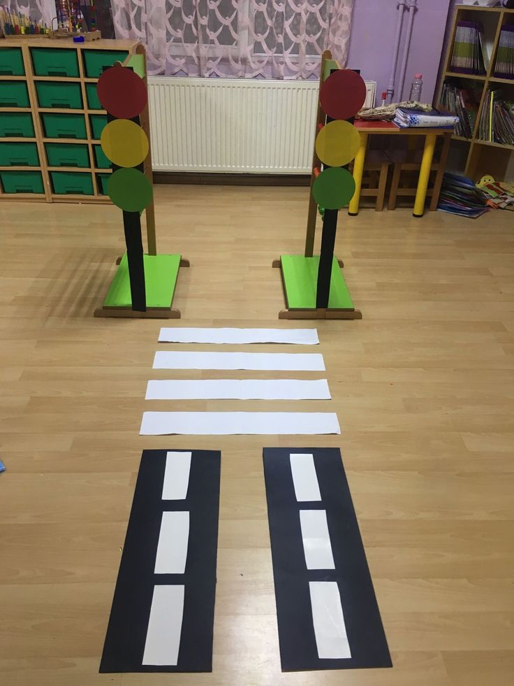 two children's play area with cut out street signs and traffic lights on the floor