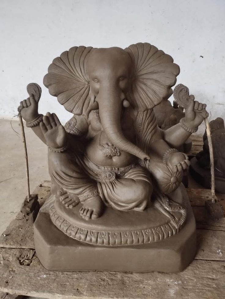 an elephant statue sitting on top of a wooden table