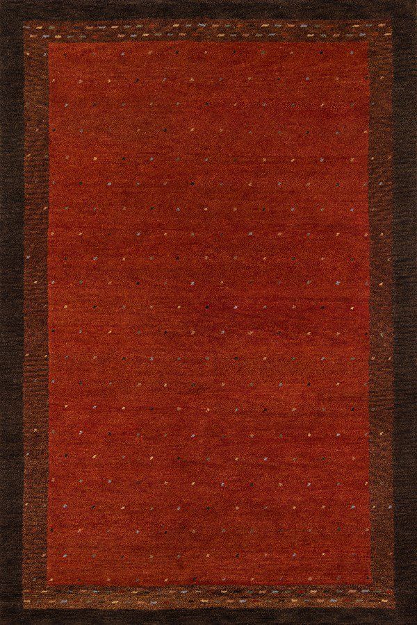 an orange and brown area rug with small dots on the border, in front of a white background