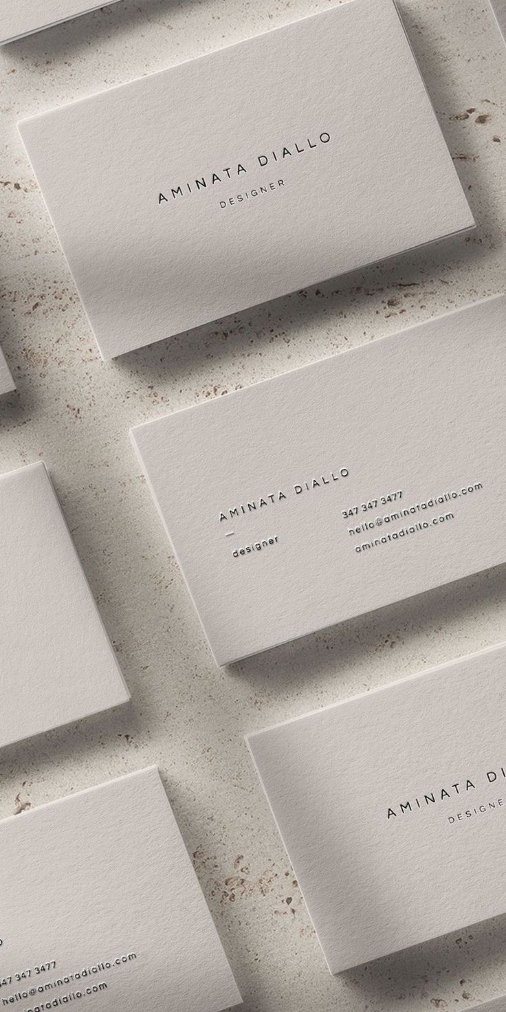 five business cards on top of each other with the name amama dallo written in white