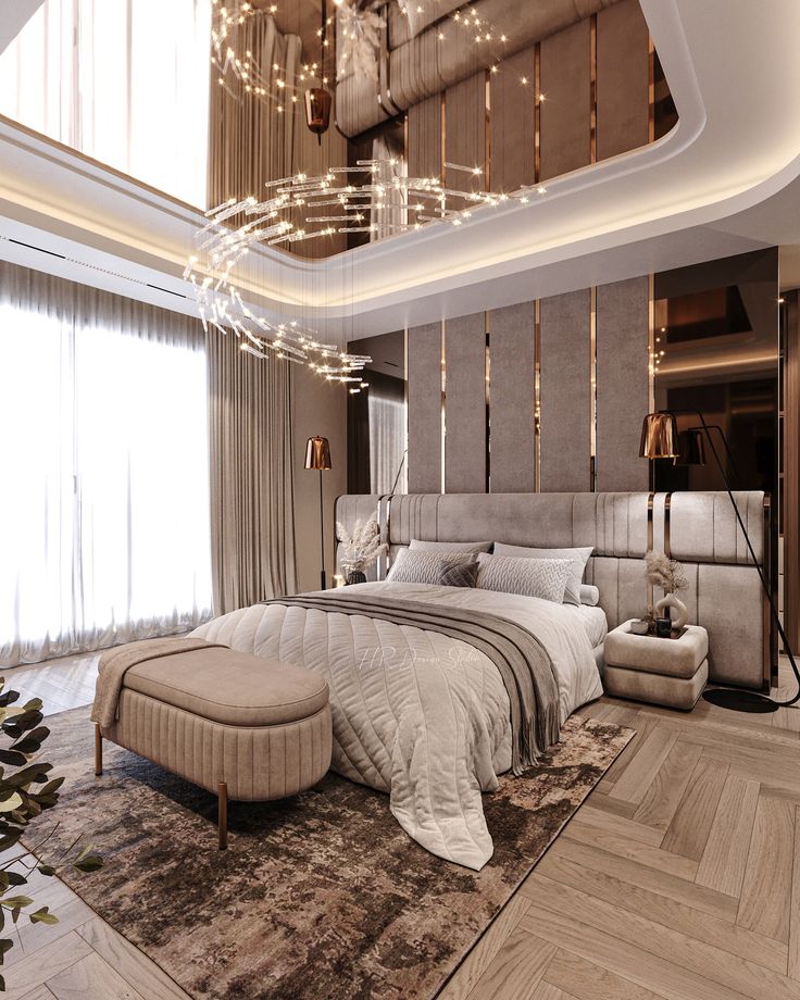 a large bed sitting under a chandelier in a bedroom