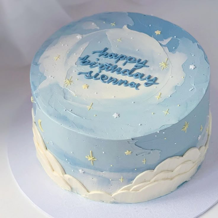 a blue and white birthday cake with stars on it