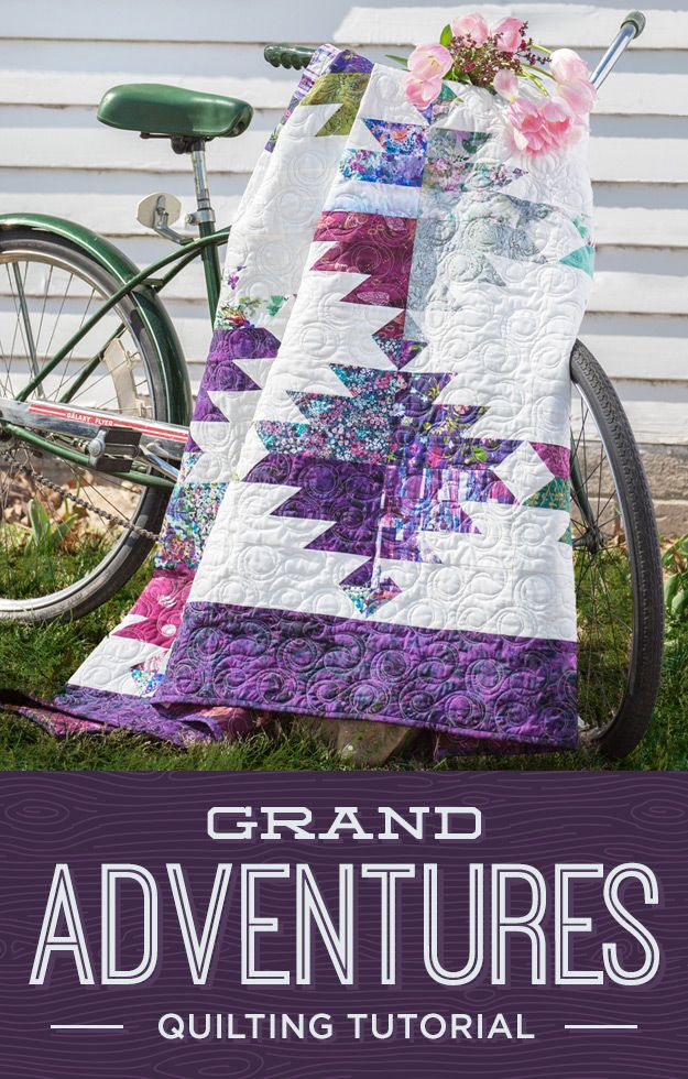 a bicycle parked next to a quilt on the grass with text grand adventures quilting tutor