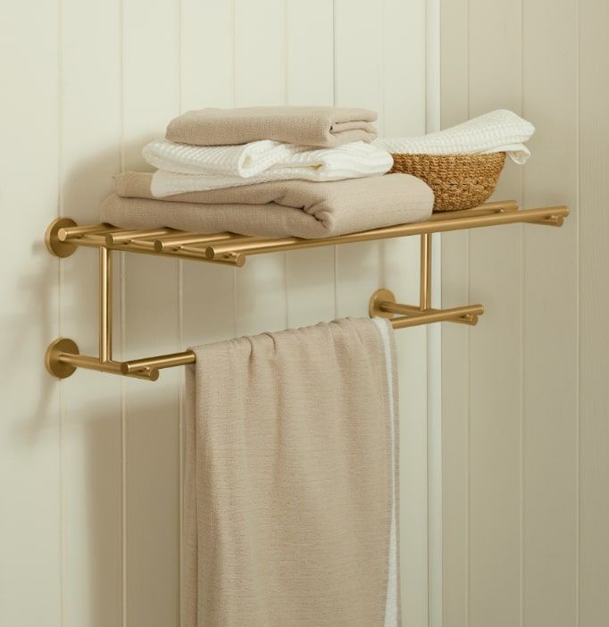 two gold towel racks with towels on them