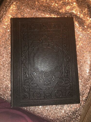 a black book sitting on top of a bed