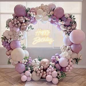 a birthday balloon arch with balloons and flowers