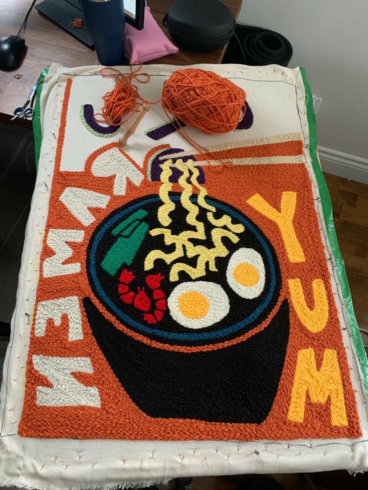 a decorated rug with an image of a bowl of food on it