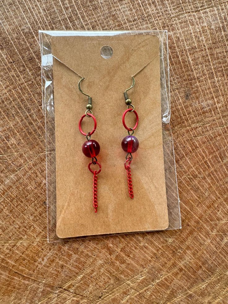 Handmade earrings made with shiny red beads and red drop-down rings! Handmade Red Crystal Drop Earrings, Red Beaded Crystal Drop Earrings, Red Beaded Drop Crystal Earrings, Red Handmade Dangle Crystal Earrings, Red Wire Wrapped Dangle Earrings, Handmade Red Crystal Dangle Earrings, Red Wire Wrapped Drop Earrings, Red Handmade Crystal Dangle Earrings, Red Round Bead Earrings With Ear Wire