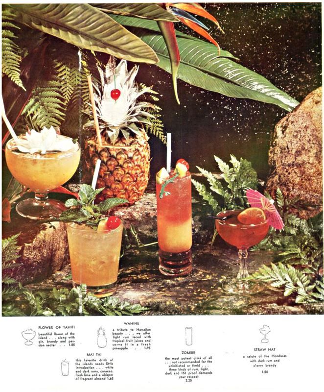 various cocktails are arranged on a table with tropical plants and rocks in the background