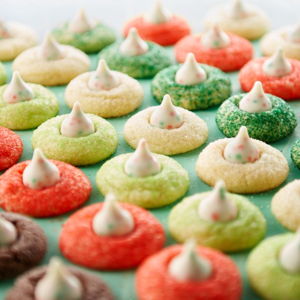 there are many colorful cookies with white frosting on them