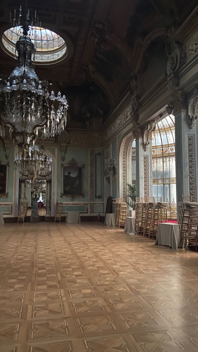 an empty ballroom with chandeliers and tables