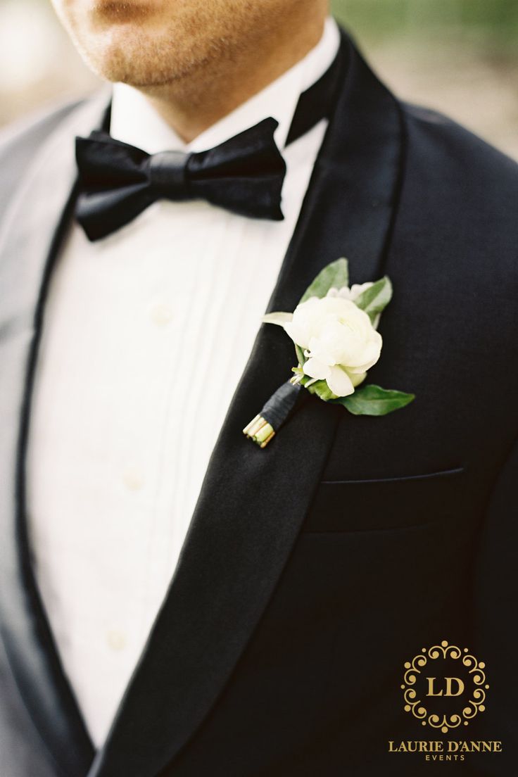 a man in a tuxedo with a boutonniere on his lapel