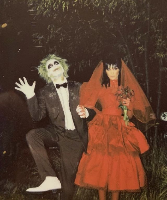 two people dressed up in costumes posing for a photo