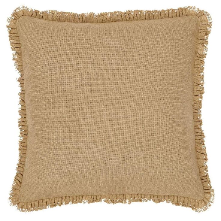 a tan pillow with fringes on it