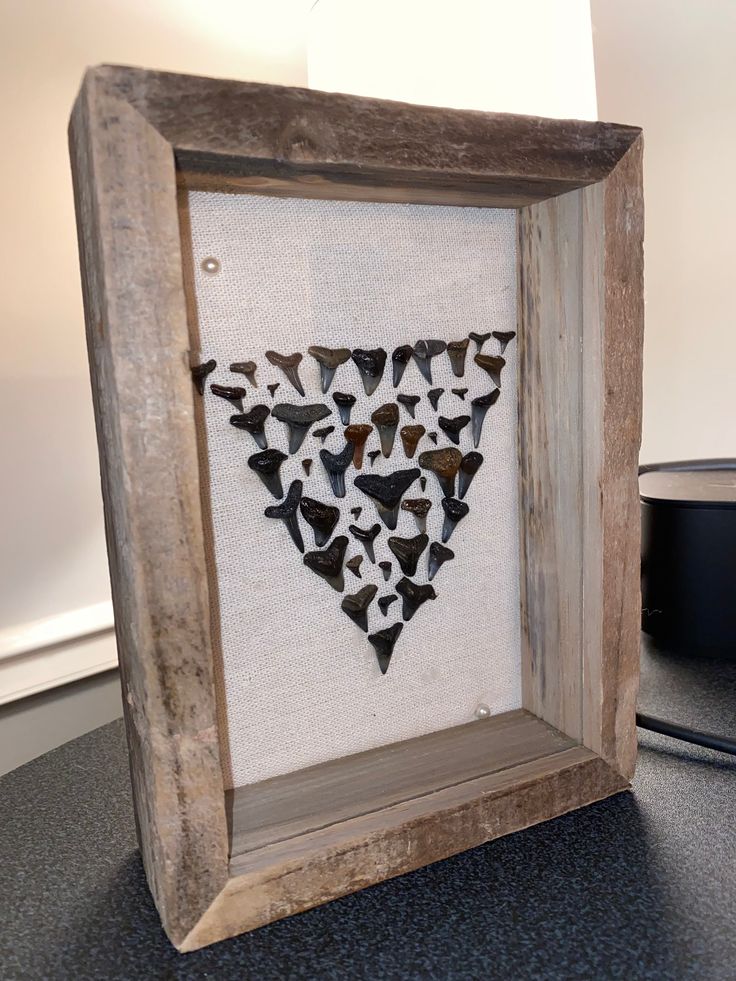 a wooden frame with some black and white shapes in it