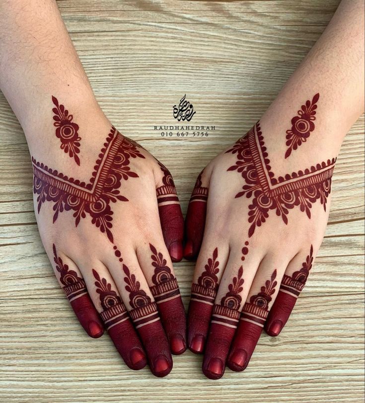 two hands with henna tattoos on them, one is red and the other is white