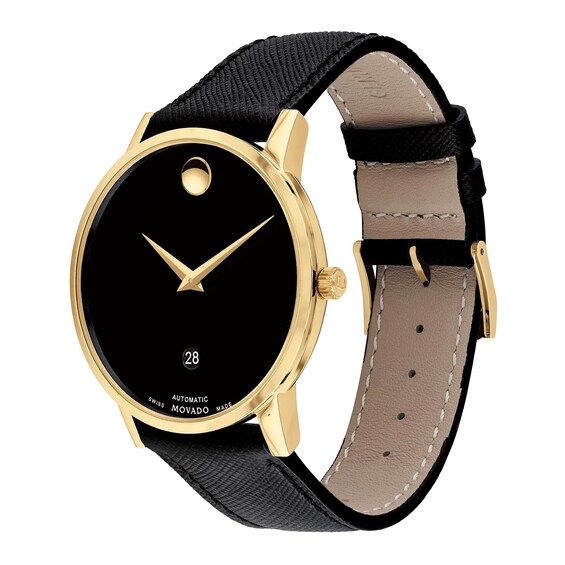 The black Museum dial of this men's watch from Movado showcases a gold-tone concave dot and hands topped by a sapphire crystal set in a 40mm gold-tone stainless steel case. The men's watch features a Swiss automatic movement, date window at 6 o'clock and water-resistance to 30 meters. The classic black calfskin leather strap secures with a buckle. Modern Black Diamond Watch, Modern Black Round Diamond Watch, Gold Business Jewelry And Watches With Round Dial, Yellow Gold Business Watches With Polished Finish, Yellow Gold Polished Business Watches, Gold Jewelry And Watches With Round Dial For Business, Modern Formal Diamond Analog Watch, Luxury Business Diamond Watch, Analog, Luxury Analog Diamond Watch For Business