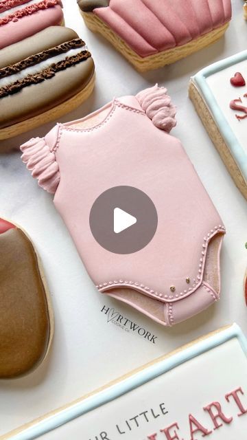 some cookies are on a table with pink icing