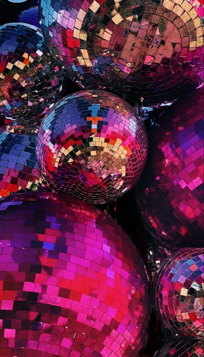 many shiny disco balls are stacked on top of each other