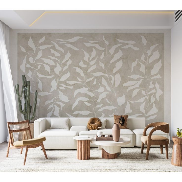 a living room filled with furniture next to a wall covered in plant stencils