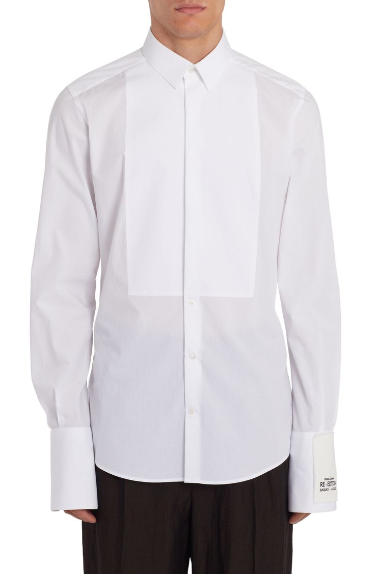 From the label's 'Re-Edition' collection comes this cotton-poplin shirt that features a partially hidden placket and a tuxedo-style bib. 31" length; 38" chest (size Medium) Front button closure Point collar Long sleeves with two-button cuffs 100% cotton Dry clean Made in Italy Men's Designer Clothing Designer White Shirt With Concealed Placket, Designer Cotton Top For Formal Occasions, Designer White Dress Shirt For Work, Designer White Top With Fold Down Collar, Designer Semi-formal Tops With Fold Down Collar, Luxury Cotton Shirt With Concealed Placket, Formal Tops With Concealed Placket And Slim Fit, Formal Slim Fit Top With Concealed Placket, Fitted Luxury Tops With Concealed Placket