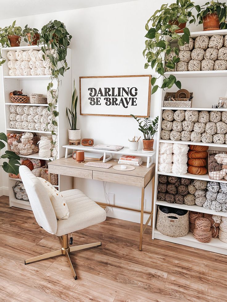 a white chair sitting in front of a desk with lots of potted plants on it