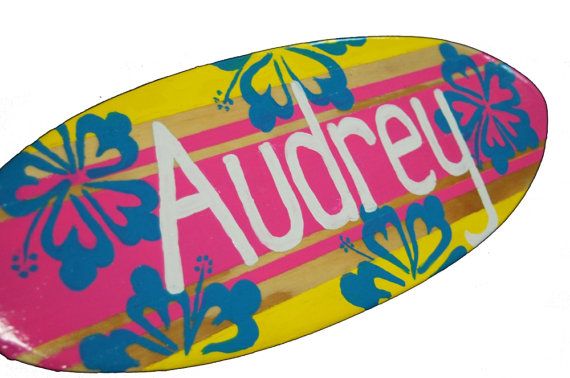 a colorful skateboard with the word audrey painted on it's bottom and sides