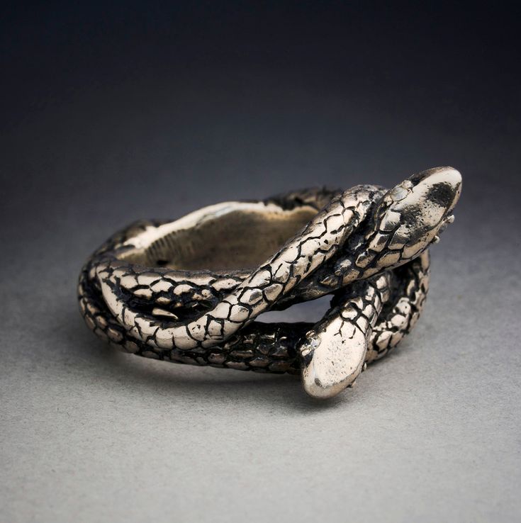 a snake skin ring on a gray surface