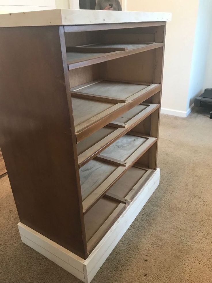 a wooden cabinet with several drawers in it