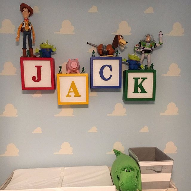 a child's room with toy blocks spelling the name jack and toys on the wall