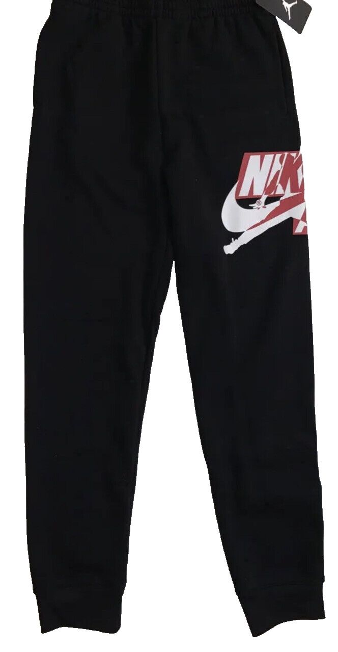 Elevate your little Jordan fan's activewear game with these NWT Nike Air Jordan Jumpman Logo black fleece joggers. The pants feature an elastic waist and tapered leg style for a comfortable and secure fit. With pockets for storage, these joggers are perfect for school, basketball, or running and jogging during fall, winter, and spring. Made from a cotton blend, these joggers are machine washable for easy care. The classic Jordan character and theme make these pants a must-have for any young athl Casual Black Joggers With Logo Print, Nike Casual Sweats For Streetwear, Nike Casual Streetwear Sweats, Black Athleisure Sweatpants With Logo Detail, Nike Moisture-wicking Joggers For Streetwear, Black Sports Sweatpants With Logo Detail, Black Logo Detail Sweatpants For Sports, Black Logo Print Joggers For Streetwear, Black Sweatpants With Logo For Sports