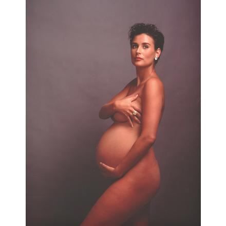 a pregnant woman is posing for a photo