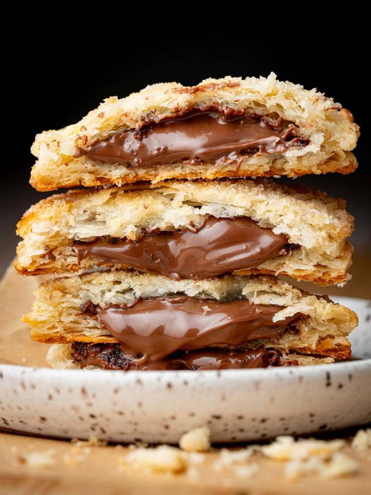 three chocolate covered cookies stacked on top of each other