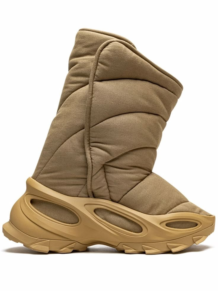 Khaki YEEZY insulated boots from adidas YEEZY featuring padded design, round toe, slip-on style and rubber sole. These styles are supplied by a premium sneaker marketplace. Stocking only the most sought-after footwear, they source and curate some of the most hard to find sneakers from around the world.. Yeezy Nsltd Boot, Knit Runner, Yeezy Boots, Insulated Boots, Khaki Fashion, Fashion Collage, Moon Boots, Shoe Design, Designer Boots