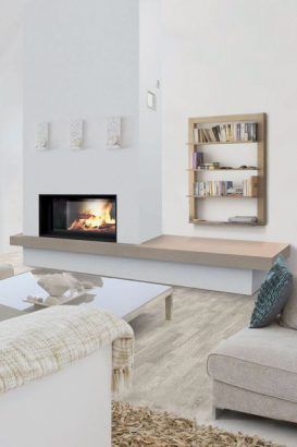 a living room with a couch, coffee table and fire place in the fireplace area