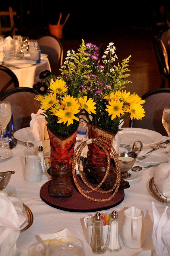 the table is set with flowers and silverware