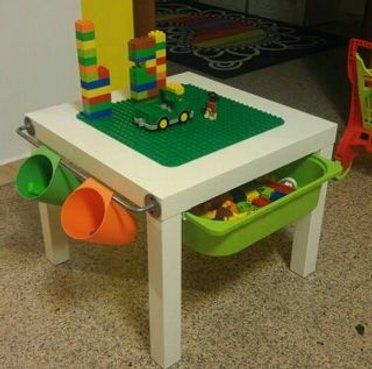 a child's table and chair with legos on it