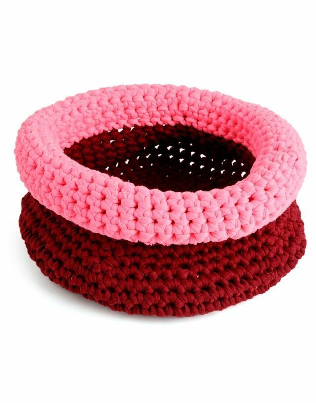 two crocheted bowls with pink and brown trims on each bowl, one has a hole in the middle