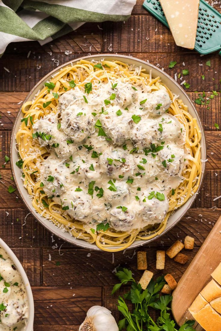 an overhead view of a bowl of pasta with meatballs and parmesan cheese