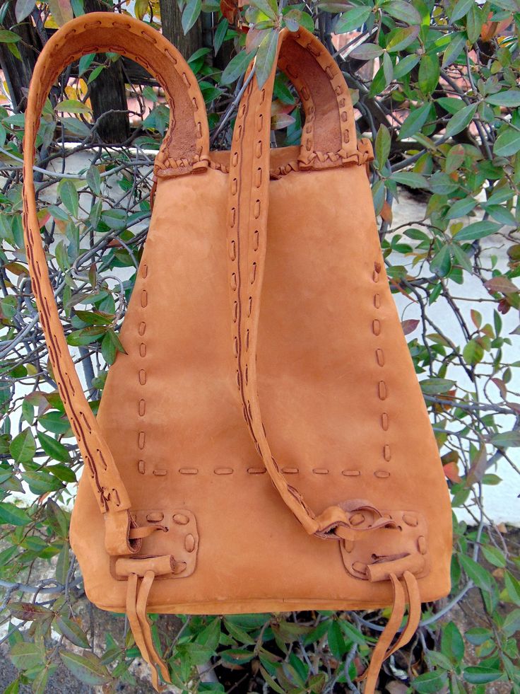 Top Cow Leather-Nabuk Tabacco Brown color-( soft velvet touch.) Handmade crossbody bag. Tobacco brown color -Fringes -Leather Feathers-Colorfull Beads- piece with turquoise stone on it !! Native American inspired- but for the people of today. Its one unique bag for all times--the real thing.!!A bag that we always wanted to find but--- can't find anywhere .!! A lot of work -hand stitched inside out!! Splendid treasure bag For people that travel a lot -beach life-sports, e.t.c. Become better with Bohemian Backpack For Festivals, Bohemian Handmade Backpack For Travel, Bohemian Rectangular Backpack For Festivals, Bohemian Handmade Travel Backpack, Bohemian Brown Backpack, Bohemian Style Brown Backpack, Bohemian Brown Standard Backpack, Bohemian Backpack In Natural Color For Everyday Use, Bohemian Everyday Backpack With Adjustable Strap